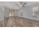 Bright living room with wood-look tile flooring and sliding glass doors at 19963 N Window Rock Dr, Surprise, AZ 85374