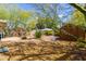 Spacious backyard with a patio, desert landscaping, a storage shed, and plenty of shade at 2231 E Weldon Ave, Phoenix, AZ 85016