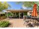 Inviting backyard patio with covered seating, lush landscaping, and a view of the well-maintained lawn at 2231 E Weldon Ave, Phoenix, AZ 85016