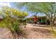 Cozy backyard patio with outdoor seating, an umbrella, desert landscaping, and a well-maintained lawn at 2231 E Weldon Ave, Phoenix, AZ 85016