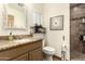 Bathroom features a granite vanity, toilet, modern decor, and tiled walk-in shower at 2231 E Weldon Ave, Phoenix, AZ 85016