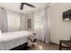 Bright bedroom with wood floors, ceiling fan, and two windows letting in natural light at 2231 E Weldon Ave, Phoenix, AZ 85016