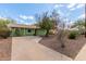 Quaint one-story home featuring a long driveway, desert landscaping, and a secure ADT security system at 2231 E Weldon Ave, Phoenix, AZ 85016
