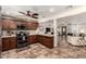 Kitchen area with wood cabinets, tile floors, granite counters, with a view to the living room at 2231 E Weldon Ave, Phoenix, AZ 85016