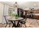 Eat-in kitchen showcasing tile floors, wood cabinets, black appliances, and a modern light fixture at 2231 E Weldon Ave, Phoenix, AZ 85016