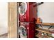 Compact laundry room with stacked red washer and dryer and custom storage shelves at 2231 E Weldon Ave, Phoenix, AZ 85016