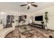 Cozy living room featuring tiled floors, modern furniture, a ceiling fan, and a view of the kitchen at 2231 E Weldon Ave, Phoenix, AZ 85016