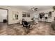 Open-concept living room with tiled floors, modern furniture, neutral decor, and a view of the kitchen at 2231 E Weldon Ave, Phoenix, AZ 85016