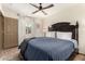 Primary bedroom boasting wood-look floors, neutral walls, ceiling fan, and plenty of natural light at 2231 E Weldon Ave, Phoenix, AZ 85016