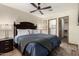 Primary bedroom features a dark wood bed frame, ceiling fan, and neutral walls at 2231 E Weldon Ave, Phoenix, AZ 85016
