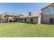 Rear view of home with patio area and lush artificial turf yard at 2254 E Becker Ln, Phoenix, AZ 85028