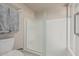 Bathroom featuring tiled shower with glass door, a toilet, and towel rack at 2254 E Becker Ln, Phoenix, AZ 85028