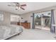 Bright bedroom with a sliding glass door to the backyard, ensuite bathroom access, and carpeted floors at 2254 E Becker Ln, Phoenix, AZ 85028