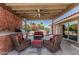 Inviting covered patio with ceiling fan, outdoor kitchen, and comfortable seating area at 2254 E Becker Ln, Phoenix, AZ 85028