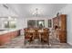 Elegant dining room features a wooden table, chairs and a view of the back patio at 2254 E Becker Ln, Phoenix, AZ 85028