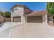 Spacious three-car garage with ample driveway space on a charming home with a red tile roof at 2254 E Becker Ln, Phoenix, AZ 85028