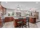 Well-lit kitchen with an island with barstool seating and a pass-through to the dining area at 2254 E Becker Ln, Phoenix, AZ 85028