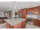 This kitchen features stainless steel appliances, custom cabinets, and a central island at 2254 E Becker Ln, Phoenix, AZ 85028
