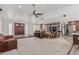 Bright and open living room featuring stone wall and a ceiling fan at 2254 E Becker Ln, Phoenix, AZ 85028