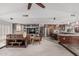 Open-concept living room features a stone accent wall, modern lighting, and seamless flow into the kitchen at 2254 E Becker Ln, Phoenix, AZ 85028