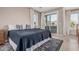 This primary bedroom features tile floors, a patterned rug, and a sliding glass door to the balcony at 2254 E Becker Ln, Phoenix, AZ 85028