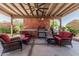Outdoor living space under a covered patio featuring a built-in kitchen and comfortable seating at 2254 E Becker Ln, Phoenix, AZ 85028
