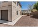 Side yard featuring a neutral color palette, gravel landscaping, and a modern stucco home at 2254 E Becker Ln, Phoenix, AZ 85028