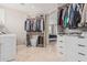 Spacious walk-in closet with built-in shelving and hanging rods. Washer and Dryer included at 2254 E Becker Ln, Phoenix, AZ 85028