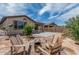 Cozy backyard features Adirondack chairs around a fire pit, perfect for relaxing evenings at 23068 E Stacey Rd, Queen Creek, AZ 85142
