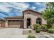 Charming single-story home featuring stucco siding, a tile roof, and a well-manicured front yard with shrubs at 23068 E Stacey Rd, Queen Creek, AZ 85142