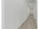 Clean, bright hallway with tile flooring, recessed lighting, and a neutral color palette at 23068 E Stacey Rd, Queen Creek, AZ 85142