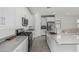 Beautiful kitchen with stainless appliances, white cabinets, gray countertops, and tile flooring at 23068 E Stacey Rd, Queen Creek, AZ 85142