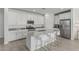 Stylish kitchen featuring white cabinets, stainless steel appliances, and a large center island with bar seating at 23068 E Stacey Rd, Queen Creek, AZ 85142