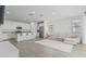 Open-concept living space featuring tile floors, a modern sofa, and a well-appointed kitchen at 23068 E Stacey Rd, Queen Creek, AZ 85142