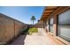 Enclosed back patio with hardscape, artificial turf, and view of a palm tree, all set in a private backyard at 2337 E Riviera Dr, Tempe, AZ 85282