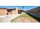 Backyard with a large, paved area, grass, and a block wall at 2337 E Riviera Dr, Tempe, AZ 85282