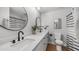 Bathroom featuring double sinks, modern fixtures, and a round vanity mirror at 2337 E Riviera Dr, Tempe, AZ 85282