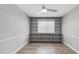 Bright bedroom featuring modern ceiling fan, built-in shelves, and wood-look flooring at 2337 E Riviera Dr, Tempe, AZ 85282