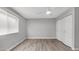 Bedroom with wood-look floors, a ceiling fan, and a window providing natural light at 2337 E Riviera Dr, Tempe, AZ 85282