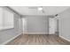 Bedroom with wood-look flooring, ceiling fan, and an adjoining bathroom with open door at 2337 E Riviera Dr, Tempe, AZ 85282