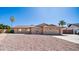 Charming single-story home with a two-car garage, desert landscaping, and mature palm trees at 2337 E Riviera Dr, Tempe, AZ 85282
