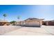 Attractive single-story home featuring desert landscaping, a two-car garage, and mature trees at 2337 E Riviera Dr, Tempe, AZ 85282