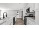 Beautiful kitchen featuring white cabinets, stainless steel appliances, and a farmhouse sink at 2337 E Riviera Dr, Tempe, AZ 85282