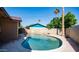 Backyard pool area surrounded by mature landscaping and block fence for privacy at 2337 E Riviera Dr, Tempe, AZ 85282