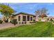 Exterior view of a charming home with a well-maintained lawn at 23705 S Pleasant Way, Sun Lakes, AZ 85248