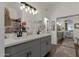 Bathroom with double vanity, sliding mirror and glass-door shower at 23705 S Pleasant Way, Sun Lakes, AZ 85248