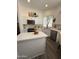Modern kitchen with white cabinets, stainless steel appliances, and a quartz island for meal preparation and dining at 23705 S Pleasant Way, Sun Lakes, AZ 85248