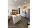 Open concept kitchen with stainless steel appliances, quartz island, and ample storage for cooking and entertaining at 23705 S Pleasant Way, Sun Lakes, AZ 85248