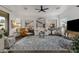 Spacious living room featuring a ceiling fan, neutral walls, and large windows, creating an inviting atmosphere at 23705 S Pleasant Way, Sun Lakes, AZ 85248