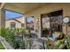 Inviting covered patio with comfortable seating, decorative fountain, and lush greenery creates a serene outdoor space at 23705 S Pleasant Way, Sun Lakes, AZ 85248